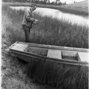 Man with boat in marshgrass