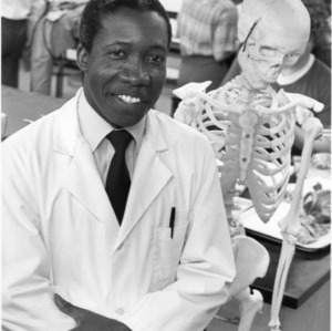 Professor W. C. Grant posing with human skeleton model