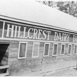 Man outside of Hillcrest Dairy Farm barn