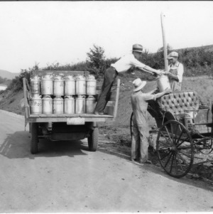 Transporting milk in truck and cart