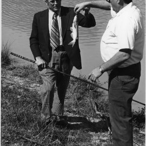 W.R. Shackelford with fish at Ike Lamm's catfish pond