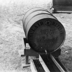 On old oil drum when equipped with float makes practical waterer for range stock