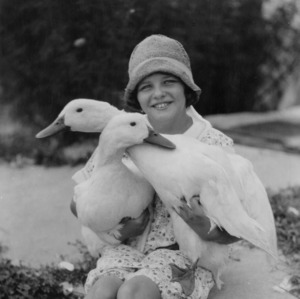 Girl holding geese