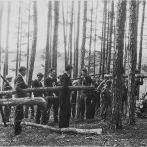 Farm boys from the Rutherfordon High School piling wood thinned from the farm of J.C. Bugg.