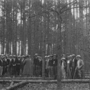 Farmers and agricultural high school students studying the management of second growth shortleaf pine at the farm of J.W. Kendricks