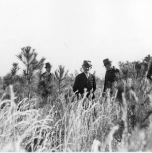 Extension Agents W. J. Barker and A. J. Harrell inspecting loblolly pine plantings