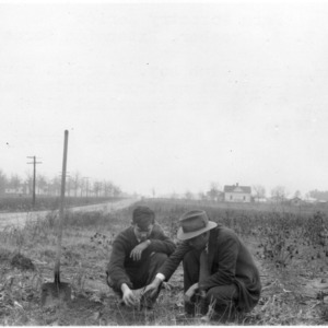 J. W. Sanders showing Fallis Finch how to transplant black walnut seedlings