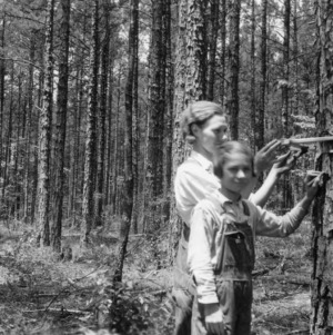 John Reitzel and children measuring standing trees