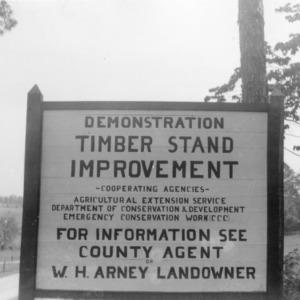 Sign notifying timber stand improvement demonstration by Agricultural Extension Service