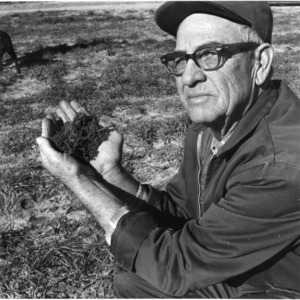 A. C. Griffin holding soil
