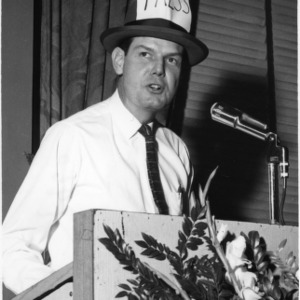 Man in comical press hat at Farm Press, Radio, and Television Institute Meeting