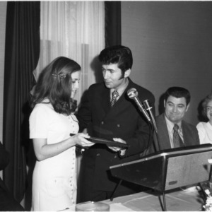 Woman receiving certificate at Farm Press, Radio, and Television Institute Meeting