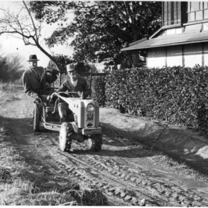 Men on tractor at a farmer's house