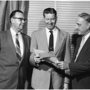 David Weaver and two other men with award and check
