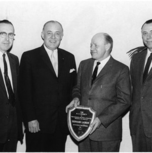 Dean Colvard, Harold Cooley, and two other men with award from The N. C. Society of Farm Managers and Rural Appraisers