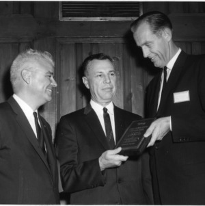 Three men with award