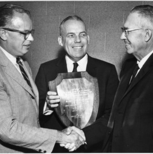 Three men with award