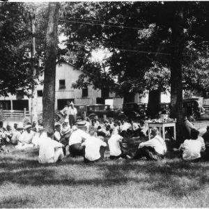Cooperative Extension agents meeting under trees