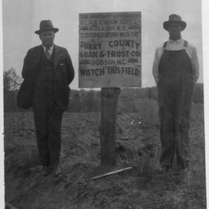 Men in front of sign notifying soil improvement demonstration