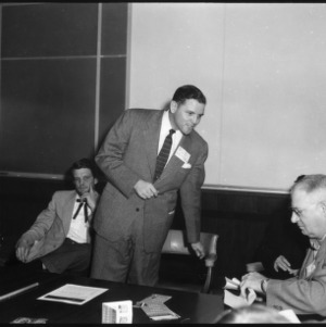 Man addressing group in conference room, Farm Press and Radio Institute