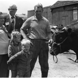 Unidentified men, woman, and children with cow on the Goodwill People to People travel mission to Europe