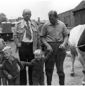 Unidentified men and children with cow on the Goodwill People to People travel mission to Europe