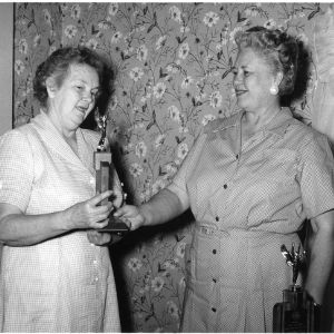 West Edgecombe Home Demonstration Club member, Mrs. J.I. Bradley (left), showing trophy to Nash County home economics agent, Mrs. Eugenia P. VanLandingham (right)