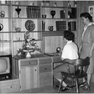 Mrs. Gwyn Caudill of Wilkesboro shows Wilkes County home economics agent, Mrs. Sue Beaver, her home office
