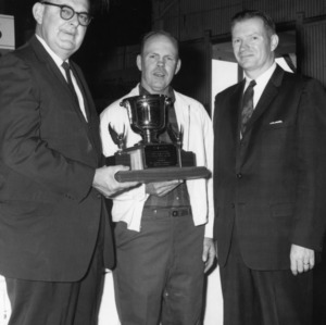 Three Men with Trophy