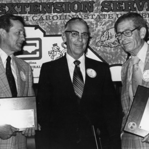Three Men with Plaques