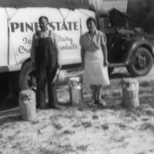 Mr. and Mrs. B. D. Adcock delivering milk cans for new milk route
