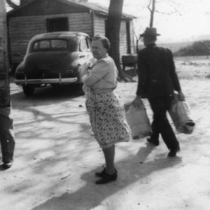 Woman delivering milk can to new milk route