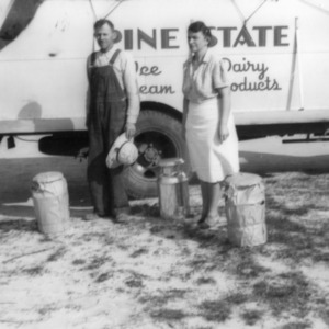 Mr. and Mrs. B. D. Adcock delivering milk cans and receiving equipment