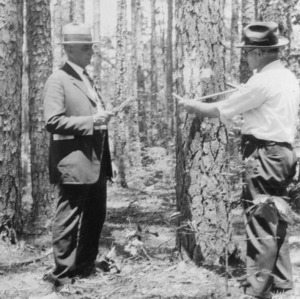 County Agent W. G. Yeager and J. C. Deaton selecting timber for cutting