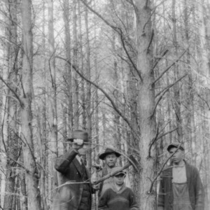 Agent J. Wade Hendricks discussing tree trimming with George Turbyfill, Emmett Turbyfill, and their father
