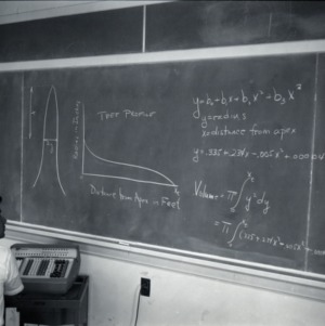 Man in front of blackboard