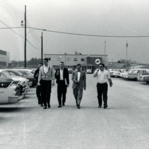 Mill visit: Men walking in parking lot