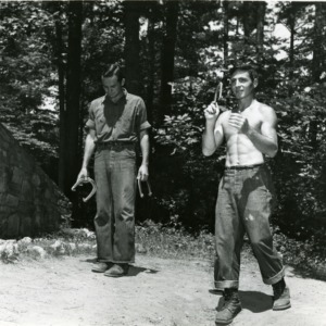 Two men playing horseshoes