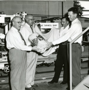 Four men in front of The Tarheel Baby machine