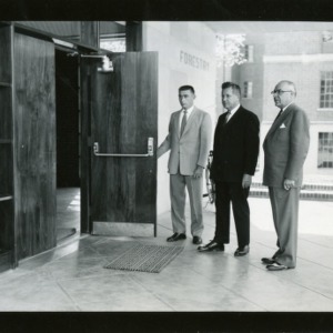 Dean James H. Hilton, Chancellor J. W. Harrelson, and Walter R. Langley (President of Forestry Club) in front of Forestry Building, Kilgore Hall