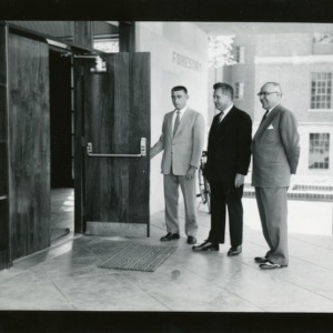 Dean James H. Hilton, Chancellor J. W. Harrelson, and Walter R. Langley (President of Forestry Club) in front of Forestry Building, Kilgore Hall