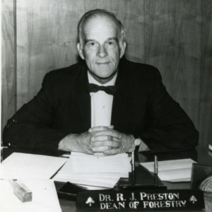 Dr. R. J. Preston at desk