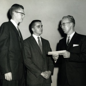 Dr. Joseph King awarding Kindred P. Magette and William H. Poole with the William J. Bridges Honorial Scholarship