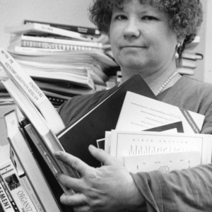 Associate Professor Lynda Aiman-Smith with loads of books