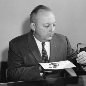Dr. William C. Bell at desk