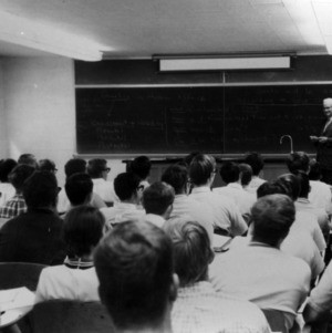 Chancellor Carey H. Bostian standing at blackboard in front of a class
