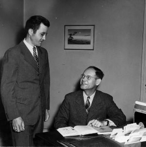 Harlan C. Brown and other at desk