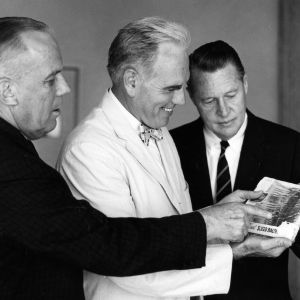 L. Y. Ballentine, Chancellor John T. Caldwell, and Archie Davis examining bacon