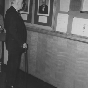 Edward L. Cloyd examining his portrait