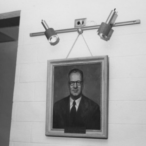 Painted portrait of Roy S. Dearstyne hanging on wall